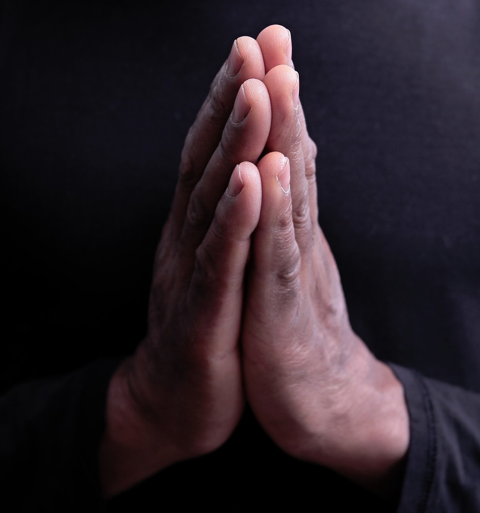 Picture of a person's hands clasped together